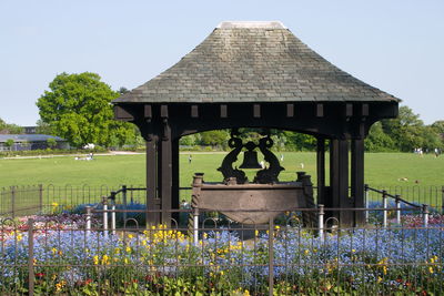 Built structure on grassy field against clear sky