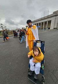 Portrait of man in kizaru cosplay with child in ninja cosplay