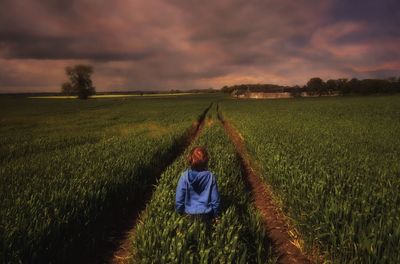 Scenic view of field against cloudy sky