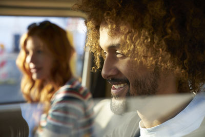 Smiling young man with girlfriend in a car