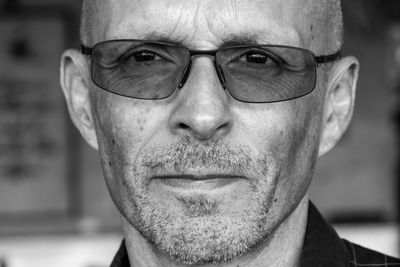 Close-up portrait of man wearing eyeglasses