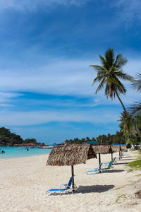 Scenic view of beach against blue sky