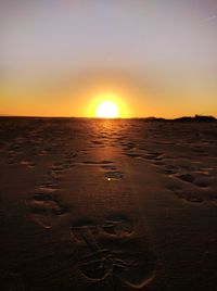 Scenic view of beach against sky during sunset