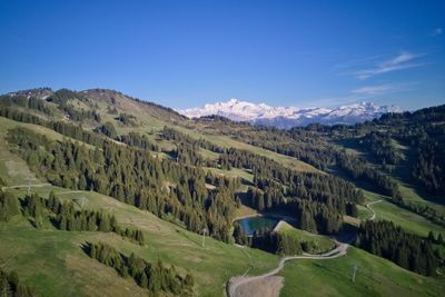 Panoramic view of landscape against blue sky