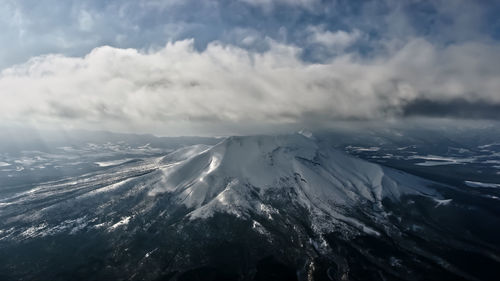 Aerial view of snowcapped mountains against sky