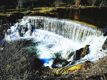 High angle view of waterfall by river