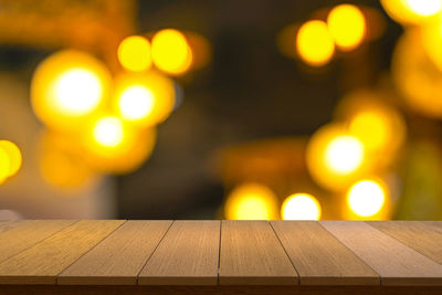 Defocused image of illuminated lights on table