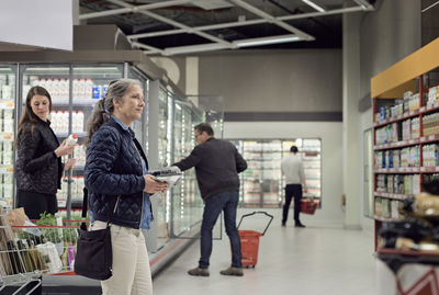 People buying groceries at supermarket