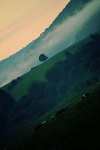 Scenic view of mountains against cloudy sky