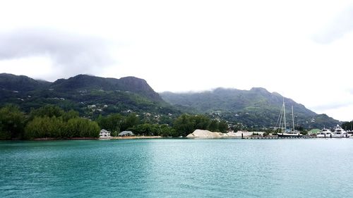 Scenic view of sea and mountains against sky