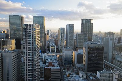 Bird aerial view of modern city high rise building against the sky