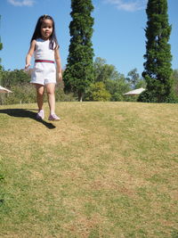 Full length of smiling woman on field