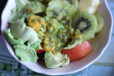 Close-up of fresh fruit salad served in bowl on table