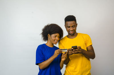 Portrait of a smiling young man holding camera