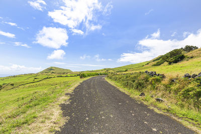 Empty road along countryside landscape