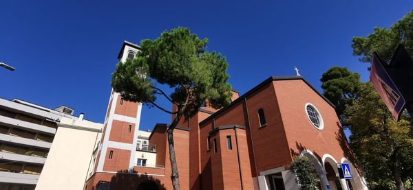 Low angle view of residential buildings against blue sky