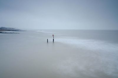 Scenic view of sea against grey sky