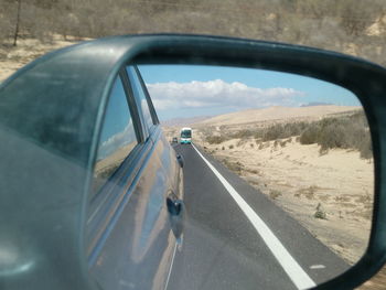 Reflection of car on side-view mirror