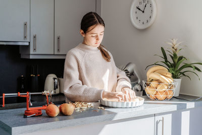 Woman standing by food at home