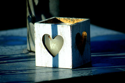 Close-up of heart shape over wood on table