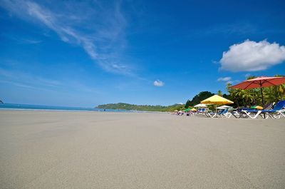 Scenic view of beach against blue sky