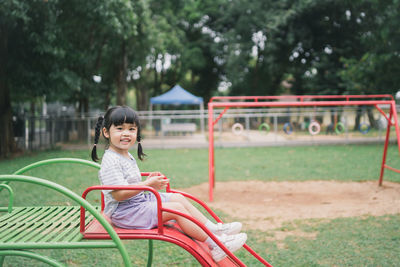 Side view of woman sitting on grass