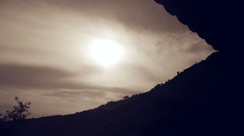 Low angle view of silhouette mountains against sky at sunset