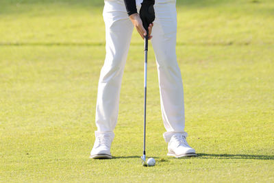 Low section of man playing golf