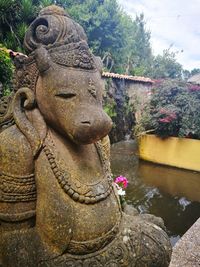 Statue of buddha against trees