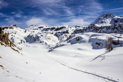 Scenic view of snow covered mountains against sky