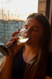 Close-up of woman drinking wine