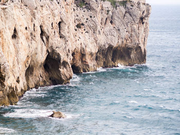 Scenic view of sea by rock formation