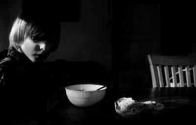 Boy having food in darkroom