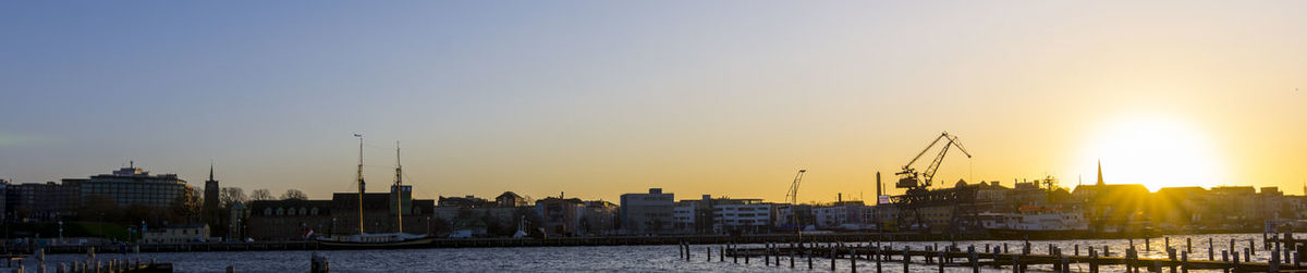 Sailboats in city at sunset