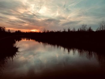 Scenic view of lake against sky during sunset