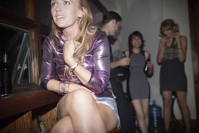 Full length of a young woman sitting outdoors