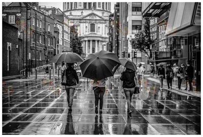 Man holding umbrella on street during rainy season