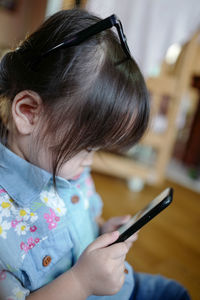 Close-up of girl using mobile phone