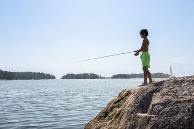 Boy fishing at lake