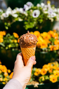 Close-up of hand holding ice cream cone