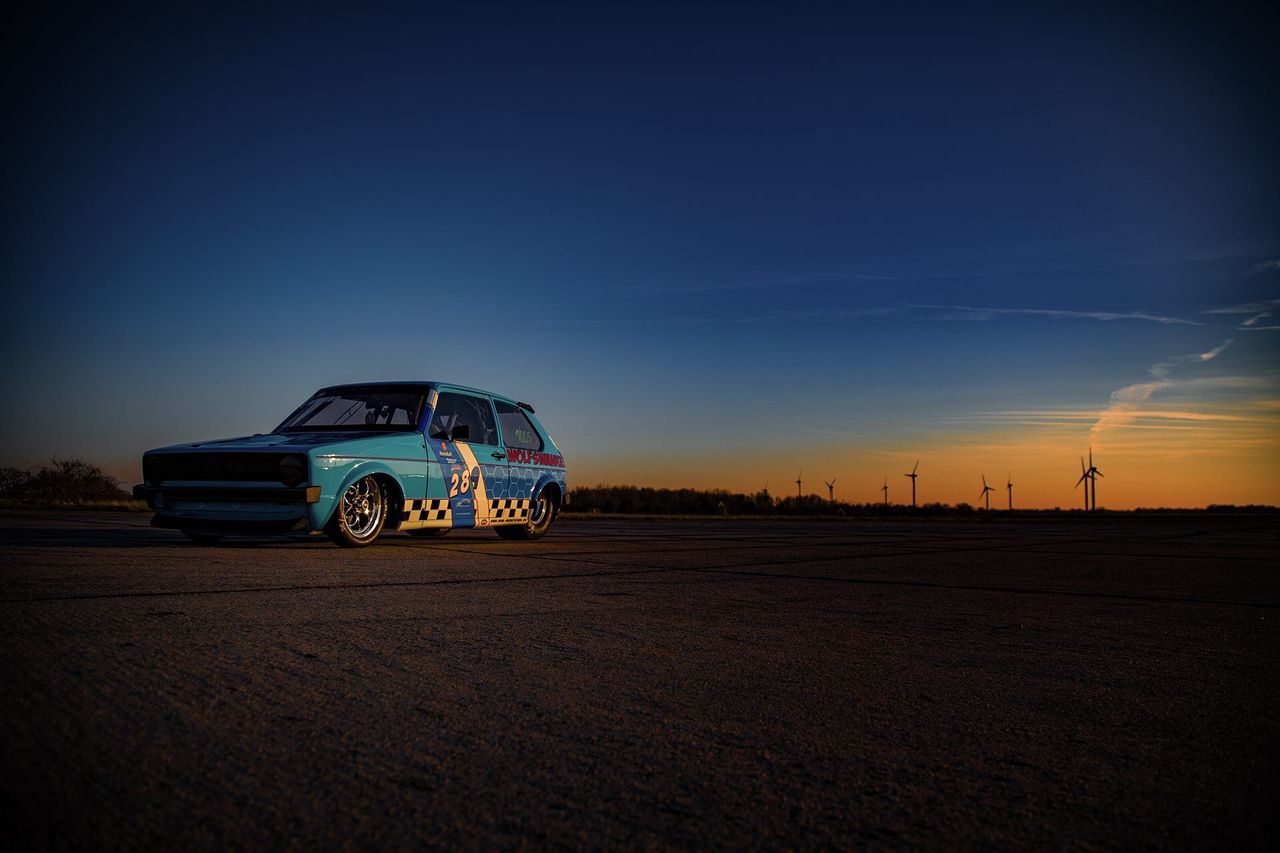 sky, mode of transportation, transportation, land vehicle, nature, land, car, sunset, motor vehicle, blue, copy space, landscape, road, scenics - nature, no people, environment, non-urban scene, horizon, desert, horizon over land, outdoors, arid climate, road trip