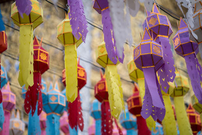 Full frame shot of multi colored decorations hanging in row for sale