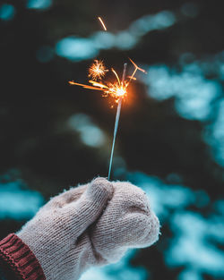 Close-up of hand holding sparkler