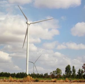 Windmill on field against sky