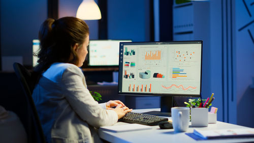 Side view of businesswoman working at office