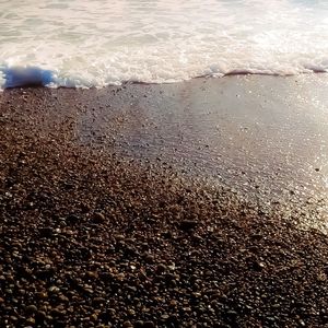 Close-up of wet sand on beach