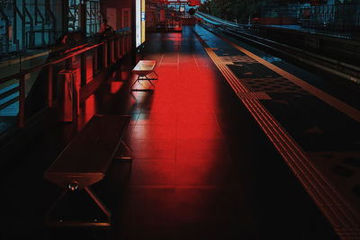Empty benches on railroad platform at night