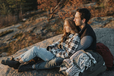 Young couple sitting outdoors