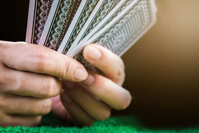 Cropped hand of person holding cards