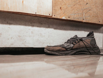 Low section of man standing on hardwood floor